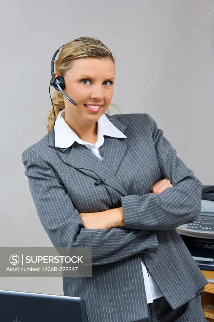 Caucasian businesswoman / secretary in her early 30s talking on a headset