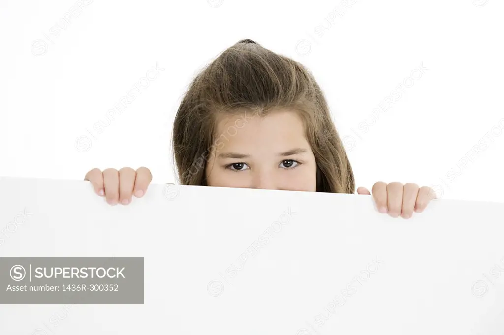 Cute Caucasian girl holding a blank sign
