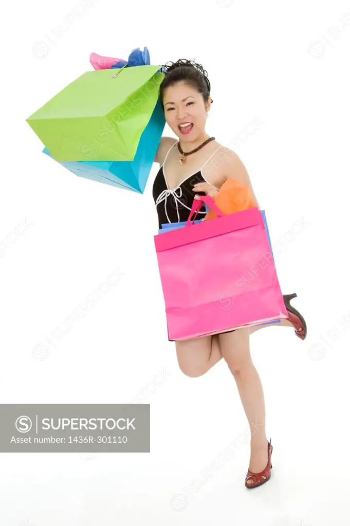 Beautiful and sexy Asian woman carrying shopping bags shopping bags