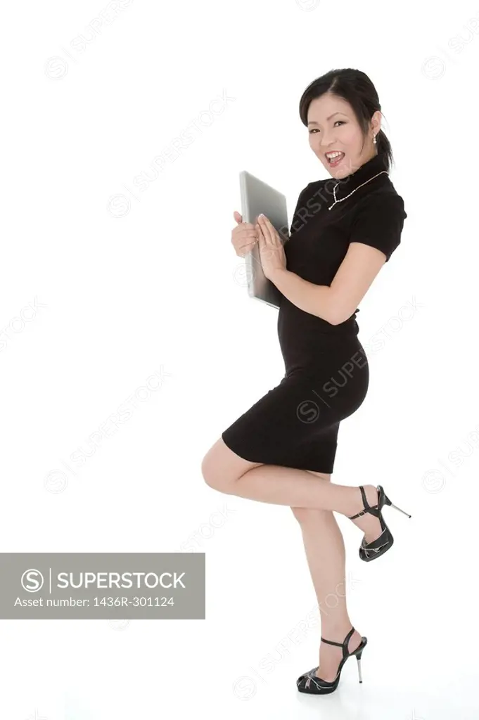 Beautiful Asian businesswoman holding a laptop computer