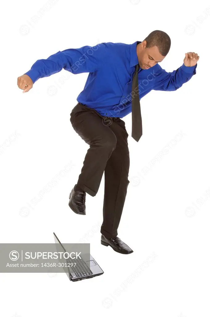 African American businessman kicking a computer on white background