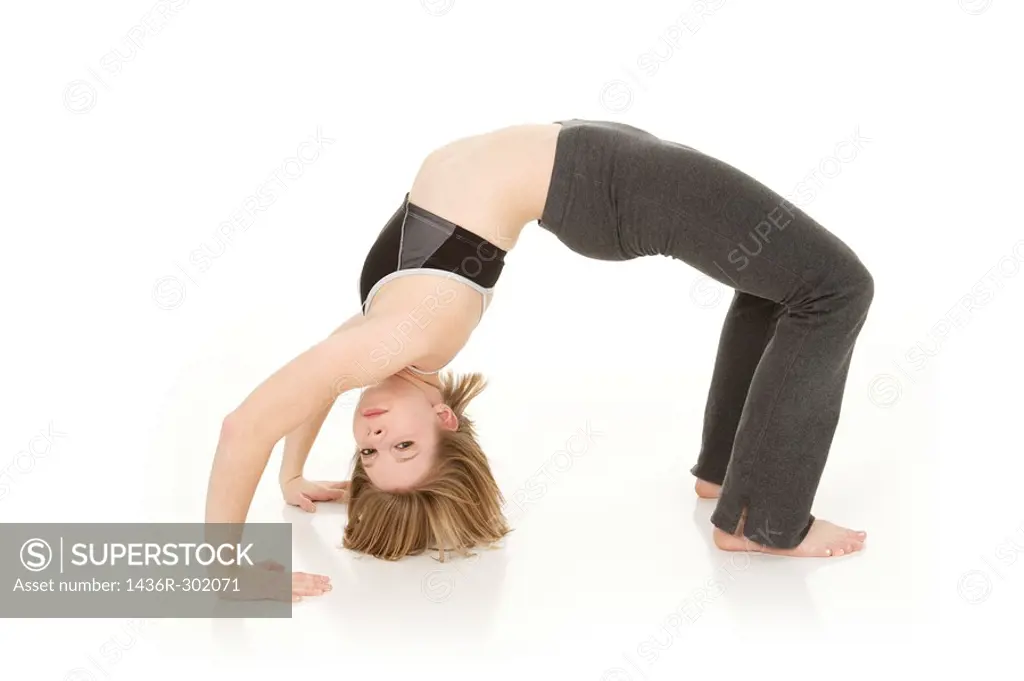 caucasian teenager practing yoga on a white background