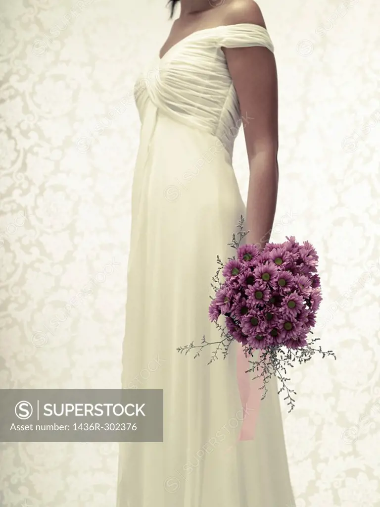 Bride in a white wedding dress holding a flower bouquet