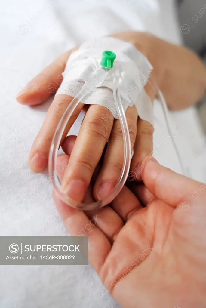Holding a patients hand at bedside