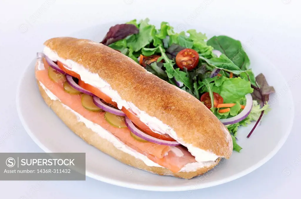Smoked Salmon sandwich served with salad