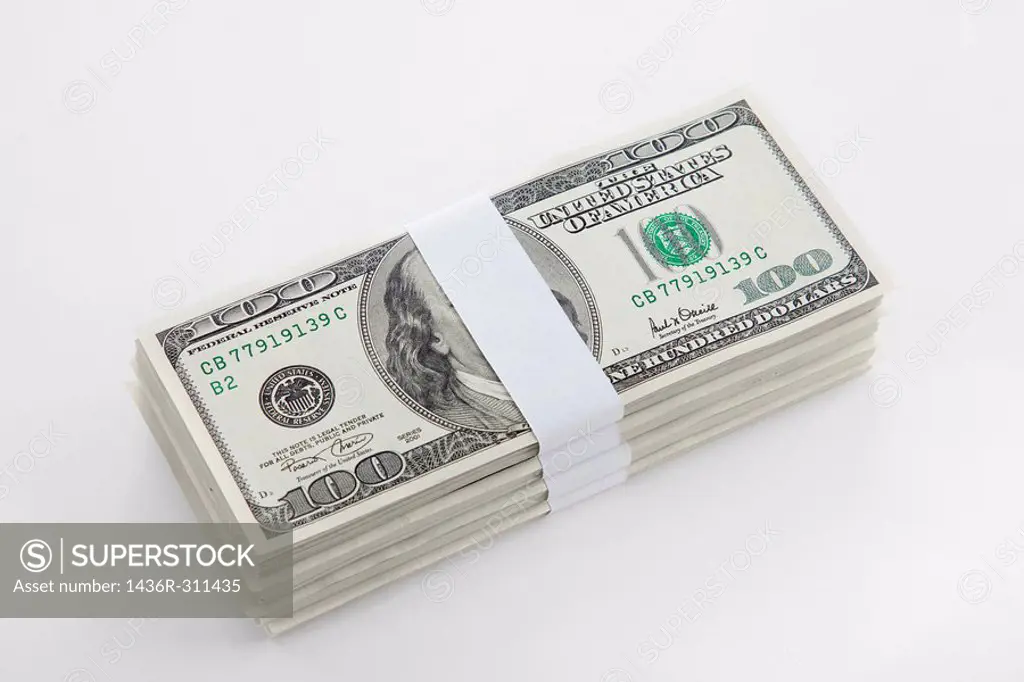 Cutout of a pile of US bank notes on white background
