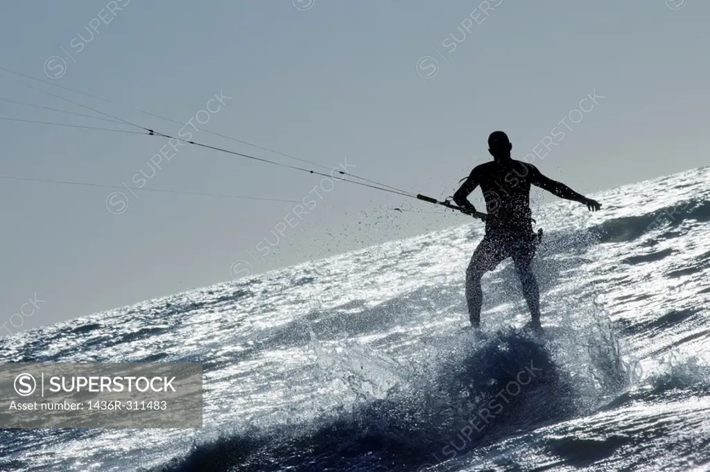 kite surfer surfing a wave in wild water