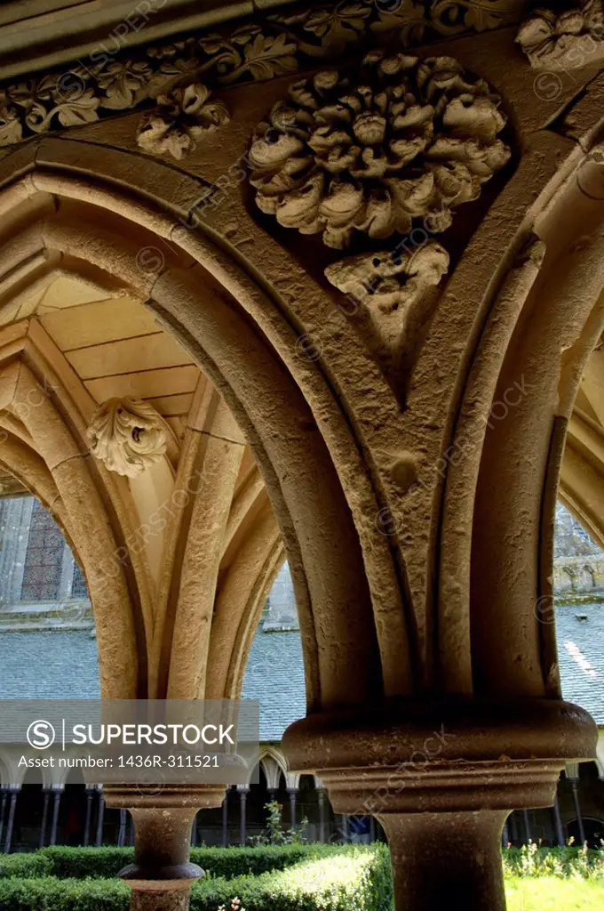 Ornate rib vault in the cloistered courtyard at Mont Saint-Michel, a fortified medieval monastery on an island in Normandy, France.
