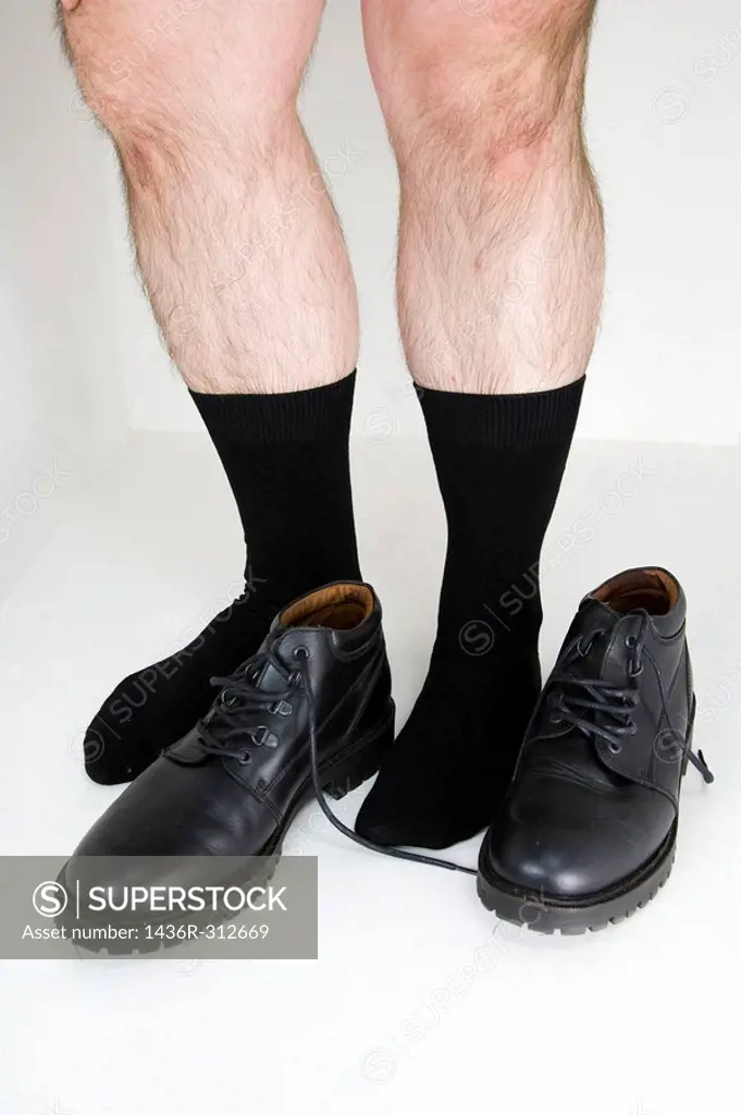 Man´s legs and black shoes.
