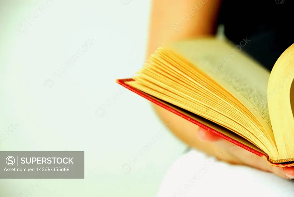 19 years old girl reading old red book.
