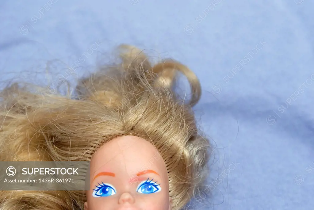 Doll lying on bed