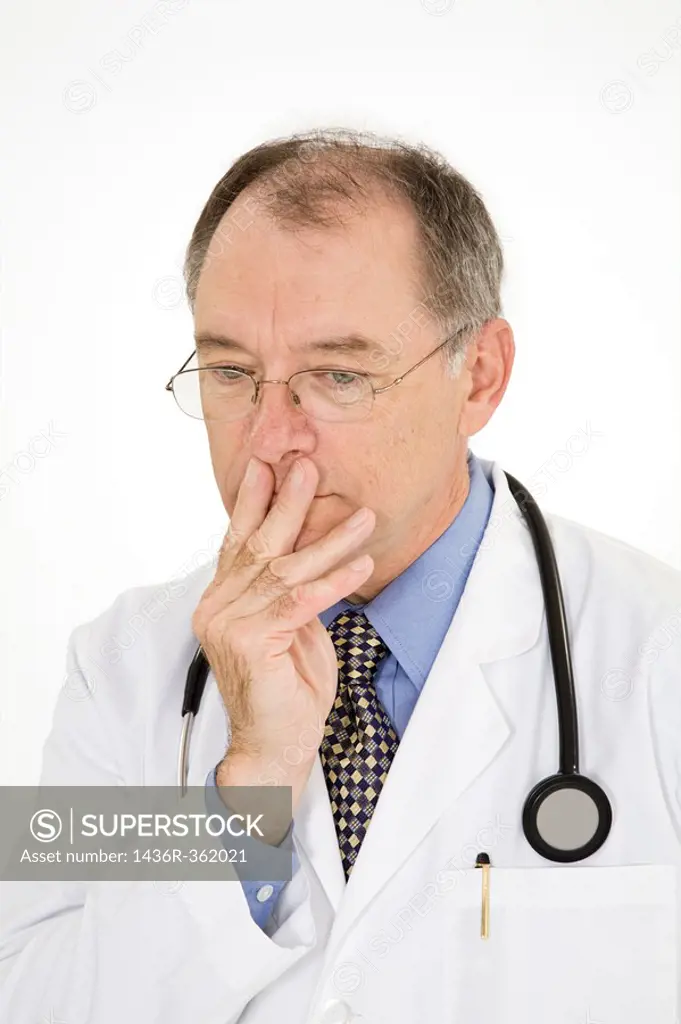 A caucasian doctor with a receding hairline wearing a white lab coat  He is shown on a white background with with a worried look on his face