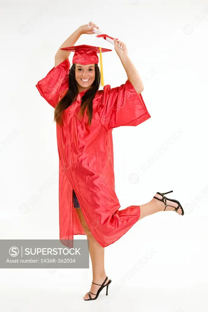 A female caucasian in red graduation gown and very excited  She is on a white background