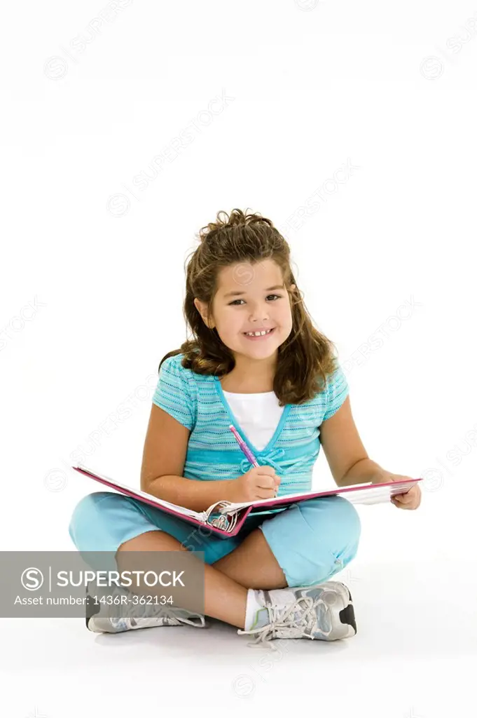 Child working on homework on white background