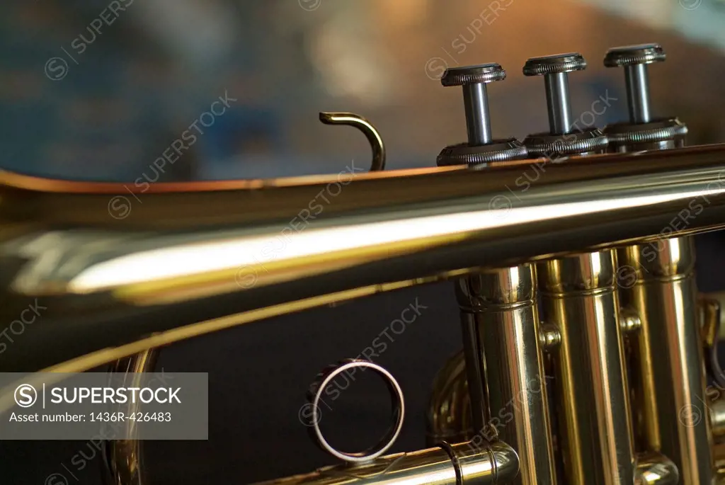 Three musical keys on a shiny trumpet