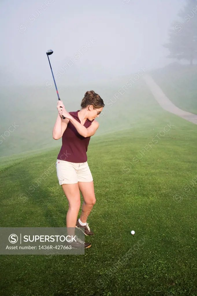 Woman in her mid 20s playing golf