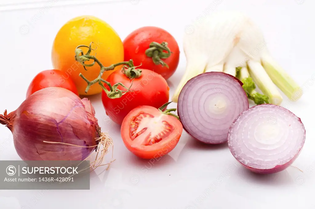 Cut and whole Purple red onion with tomatoes and fennel bulbs on white Background
