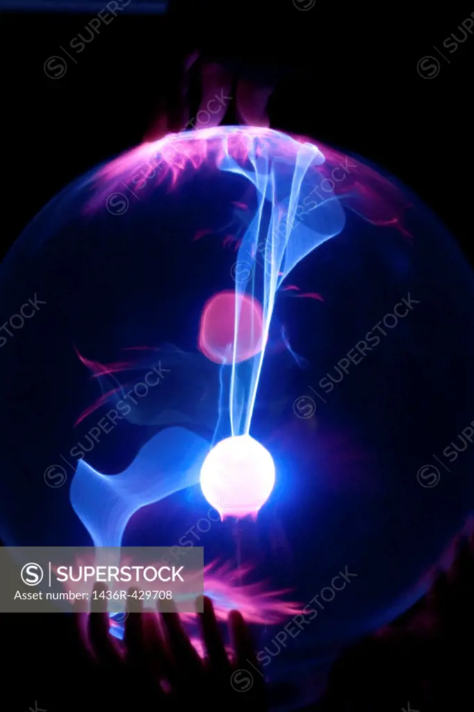 Small children´s hands on a Plasma Globe