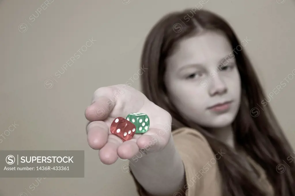 Preteen girl holding colored dice