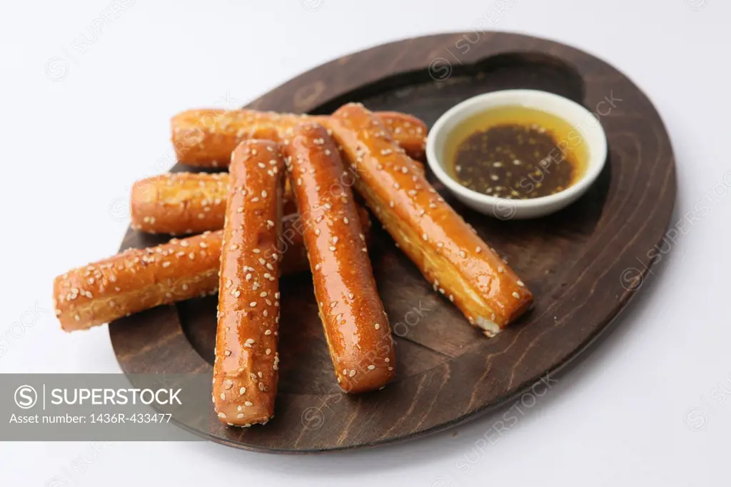 Grissini Breadsticks on wood plate and dip