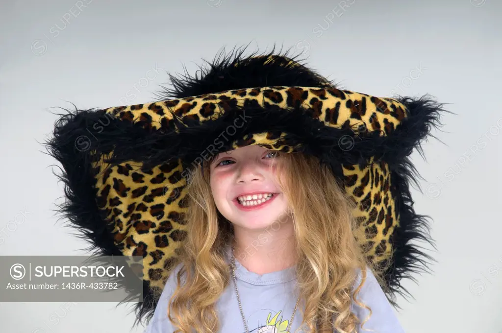 Smiling young girl of three with leopard fur hat