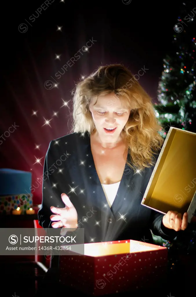 Blond woman opening Christmas present
