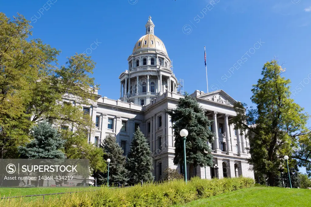 Front of the Colorado state capitol building with gold dome taken from side lawn