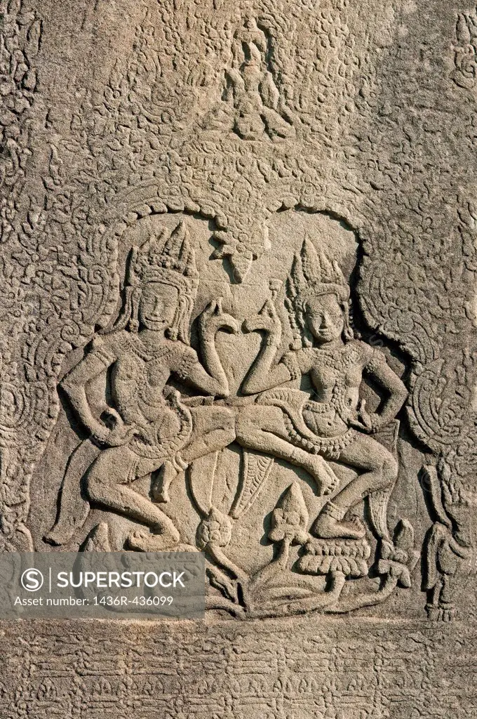 Two Apsaras dancing on lotus flowers framed by intricate and intertwined leaf patterns, Bas-relief carved in stone, Bayon temple, Angkor Thom, Siem Re...