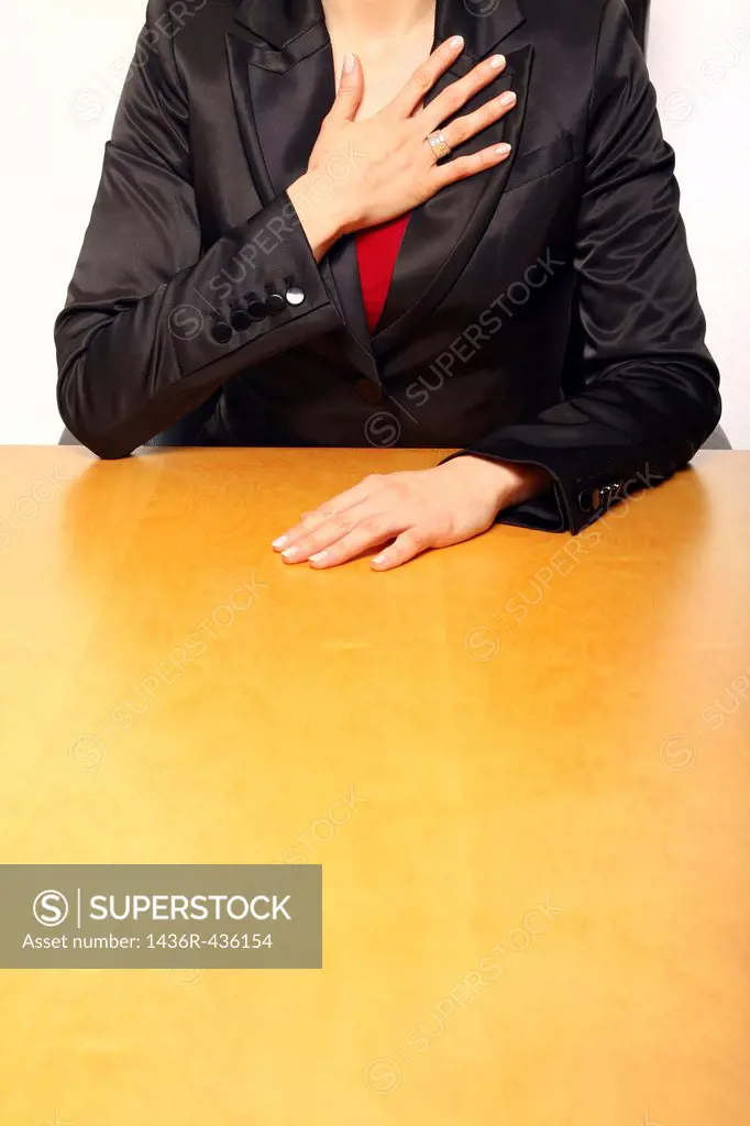 View of a business-woman sitting at the desk gesturing