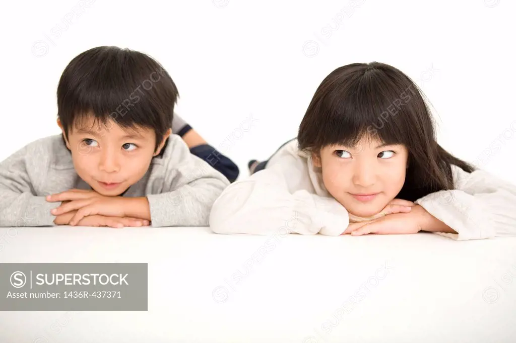 Boy and girl lying on stomach
