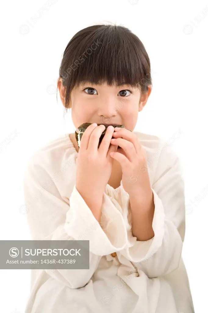 Girl eating rice ball