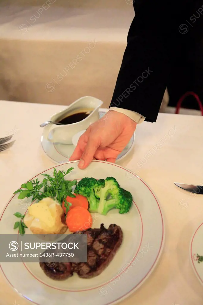 Waiter Serving Beef Steak
