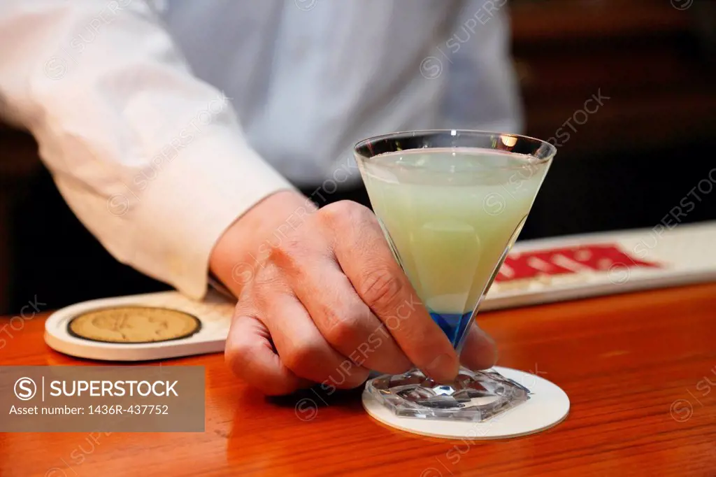 Bartender Holding a Glass of Cocktail