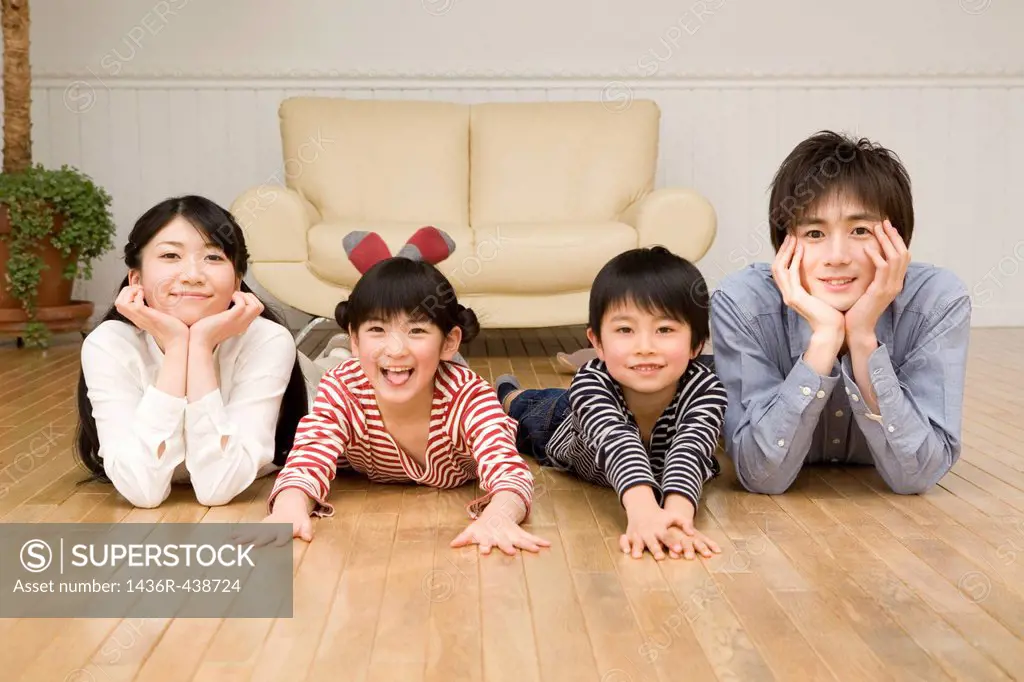 Family lying on wooden floor