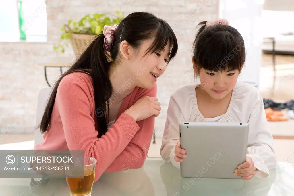 Mother and daughter using tablet computer