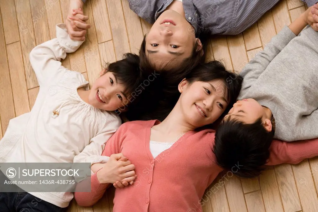 Family lying on wooden floor