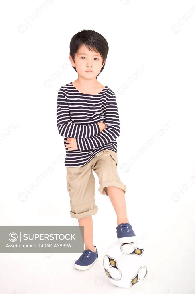 Boy making pose with soccer ball