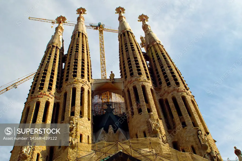 La Sagrada Familia, with construction cranes in situ, Barcelona, Spain