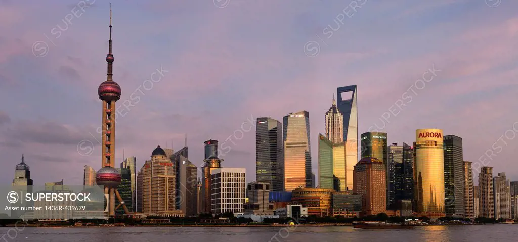 Red sky and dusk light on high rise financial towers and hotels in the Pudong east side of Shanghai China