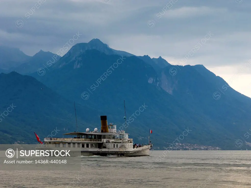 An old paddle-steamer as a ferry for tourists approaching a dock near Montreux, Switzerland, Europe