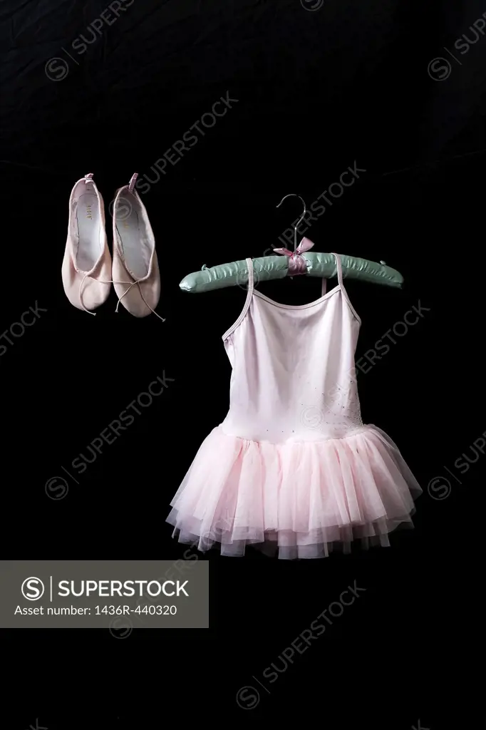 Ballet dress on a satin hanger with ballet shoes