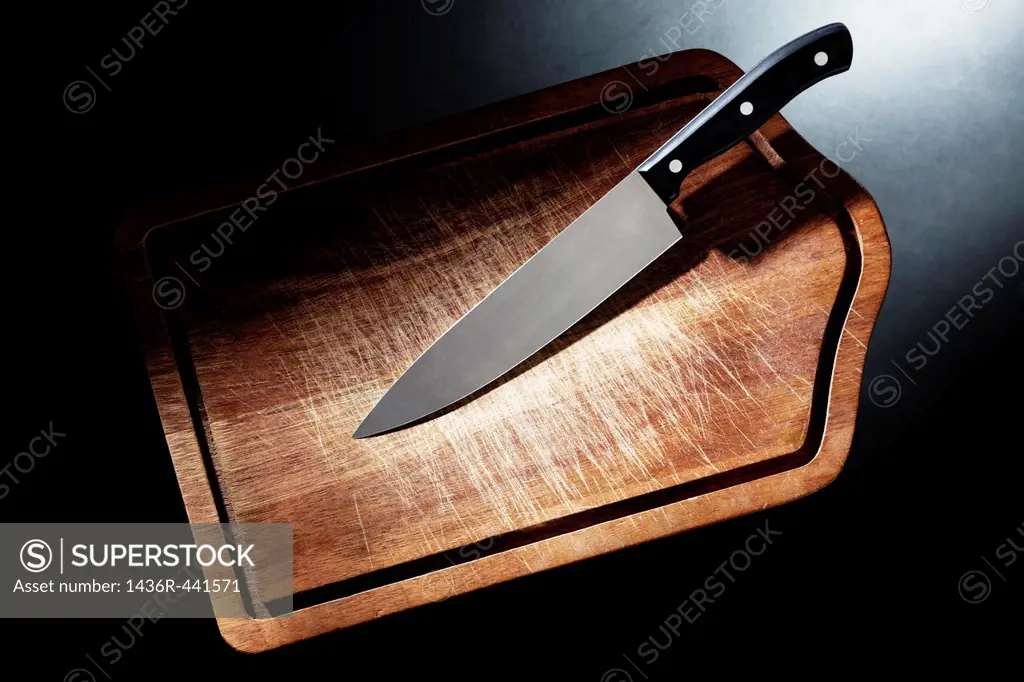 a knife with a chopping board