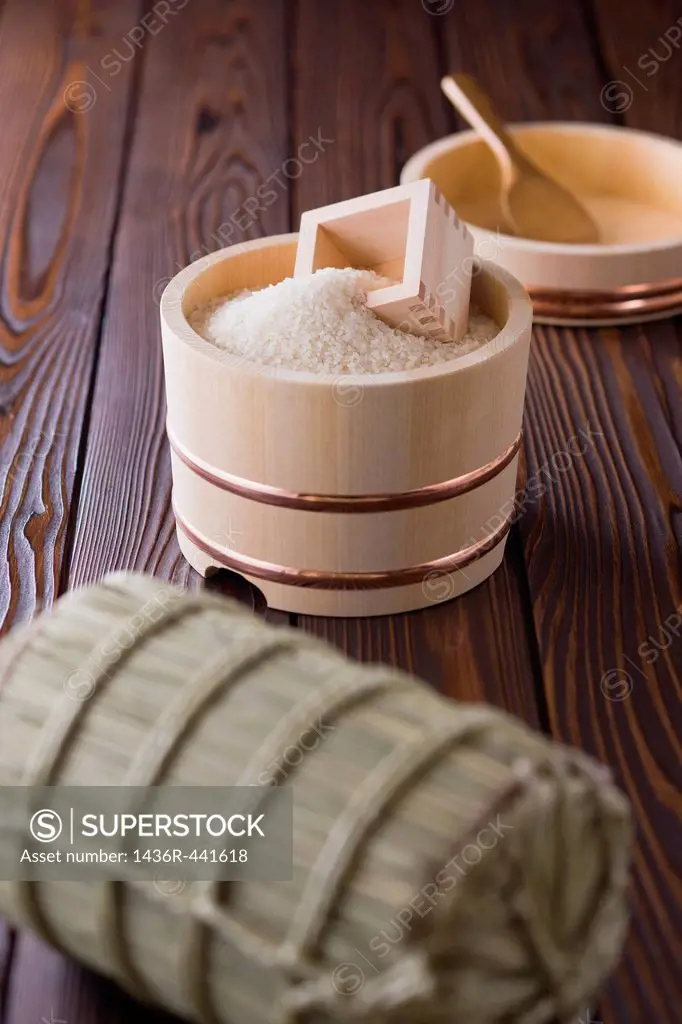 Rice and Measuring Cup in Wooden Tub