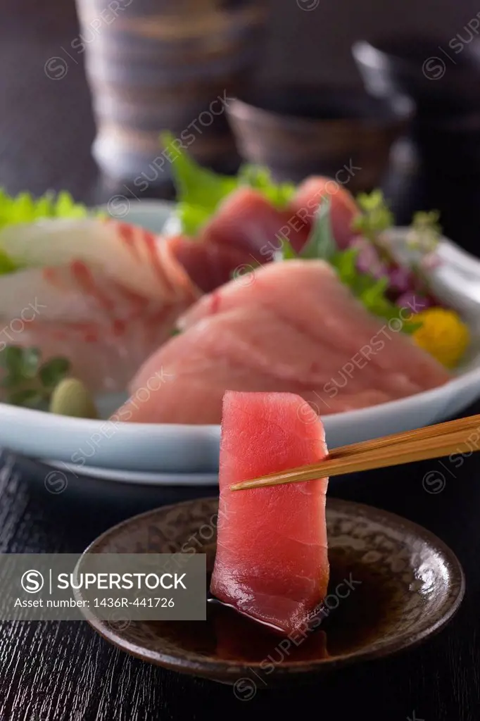 Lean Tuna Sashimi Dipped into Soy Sauce