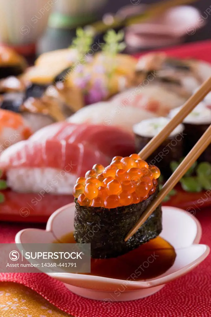 Salmon Roe Sushi Dipped into Soy Sauce