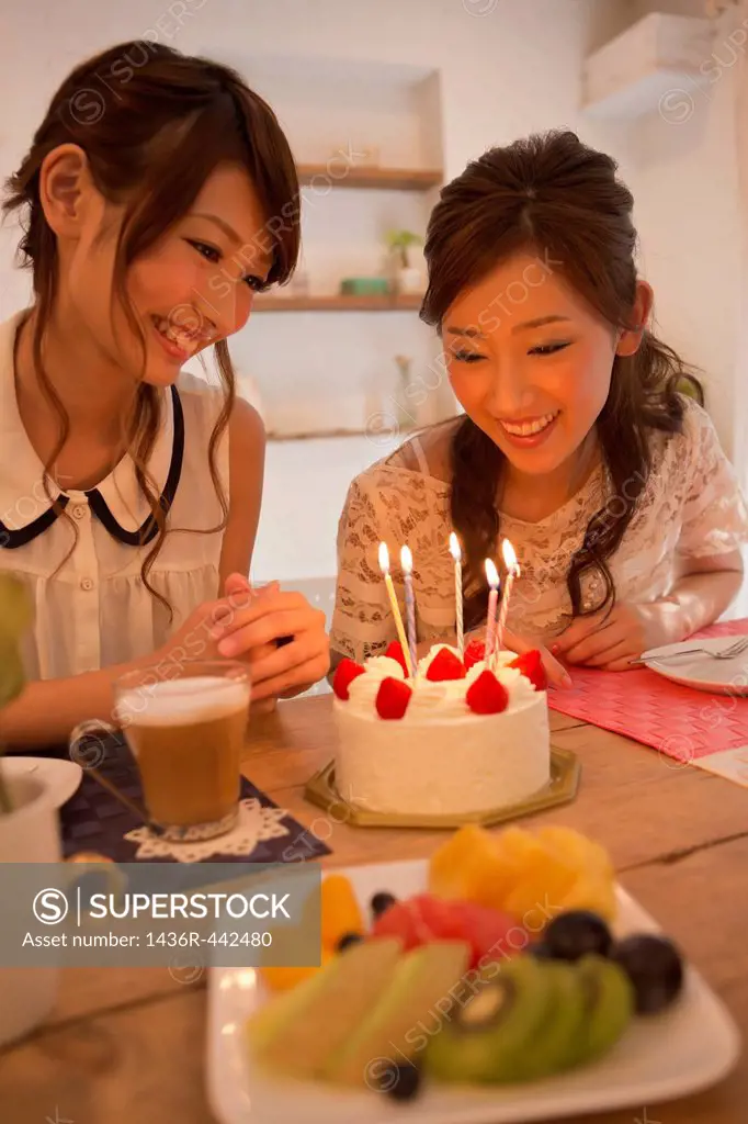 Three Young Women Looking at Birthday Cake