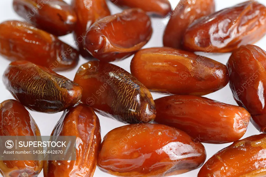 Close up of ripe sweet date palm fruit on white background