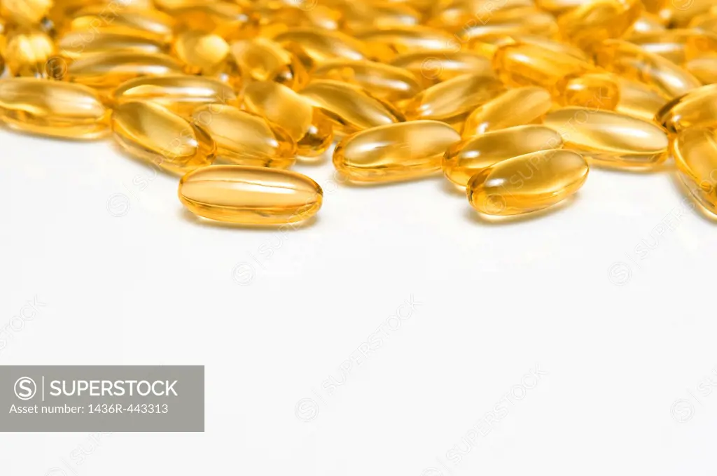 Beautiful Golden Fish Oils Capsules on a White Background