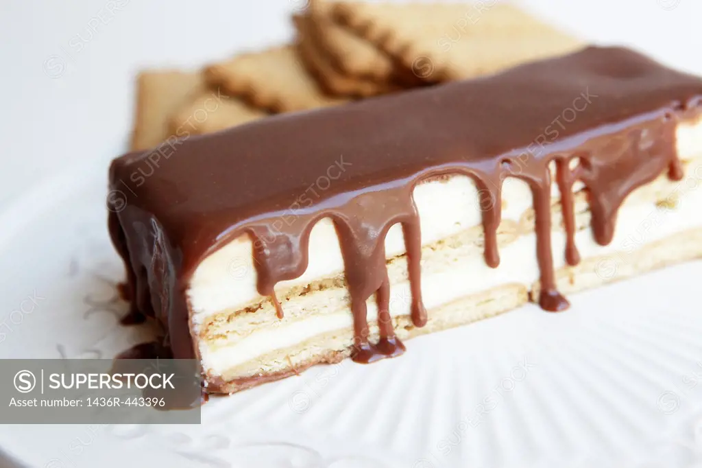 biscuit layer cream cake topped with chocolate  Base and layers are made from biscuits seen in the background