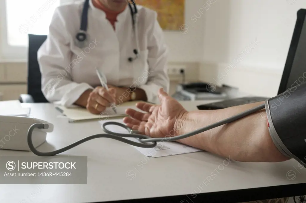 Doctor takes patients blood pressure